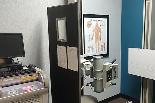 Chart, Computer, and Back Pain Treatment Machine of Chiropractor's Office Near Phoenix and Tolleson AZ