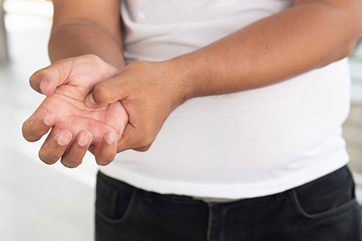 Unknown Man from Phoenix Arizona Pressing Hand In Need of Tolleson Carpal Tunnel Treatment Chiropractor