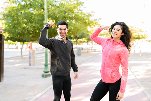 Phoenix Lady and Tolleson Man Flexing Muscles During Run After Visiting Local Chiropractor