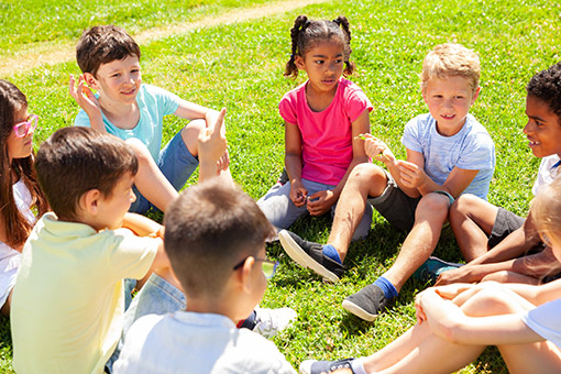 Kids in a Tolleson AZ Neighborhood Listening as Phoenix Boy Shares Experience with Pediatric Chiropractor