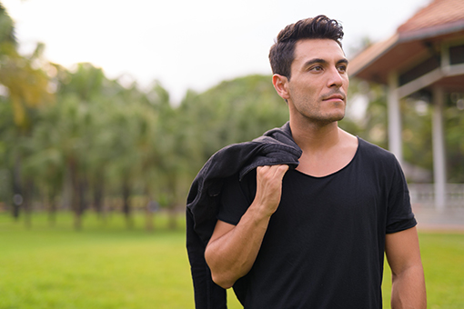 Tolleson Man Who Had Physiotherapy Holding Jacket While Walking in Phoenix Arizona