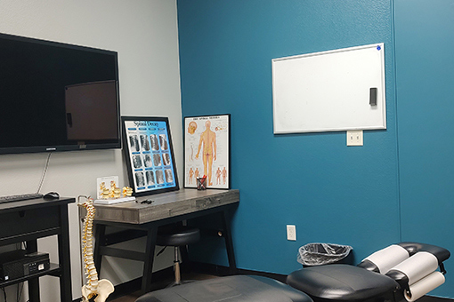 Motorcycle Accident Chiropractor in Phoenix AZ Bed and Charts in a Chiropractor's Clinic Serving Phoenix Residents Involved in Motorcycle Accident