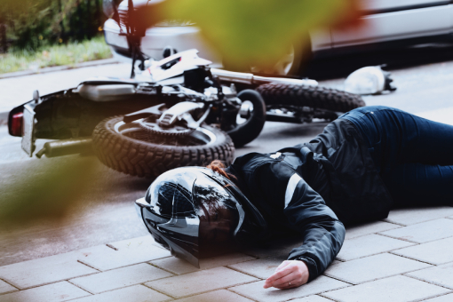 Tolleson Lady Lying on the Ground In Need of Chiropractor Specializing in Motorcycle Accident Injuries