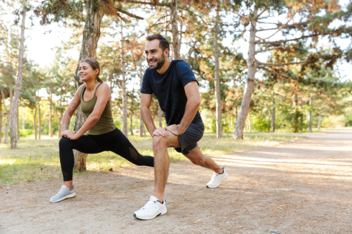 Couple From Tolleson AZ Doing Stretches in a Park After Successful Visits with Their Disc Injury Chiropractor
