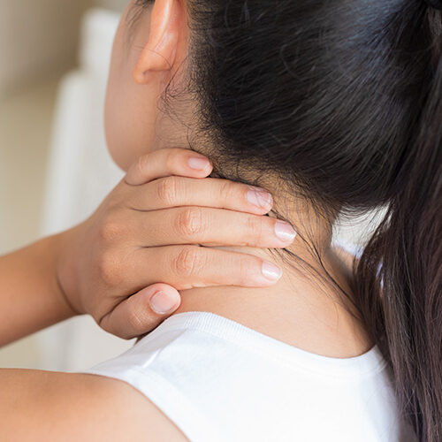 Phoenix Lady Touching Neck in Pain During Visit at Chiropractor's Office in Tolleson AZ