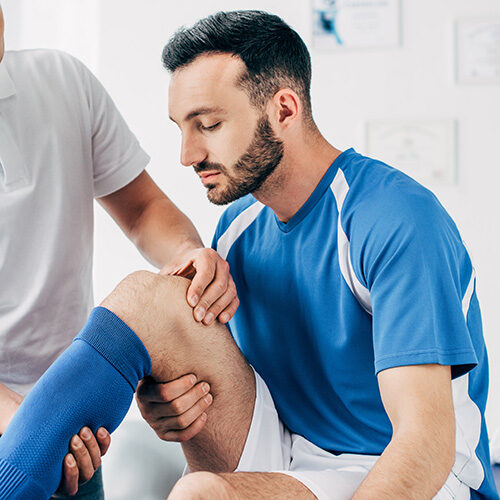 Athlete Playing for Phoenix Team Having Leg Checked by Tolleson Chiropractor